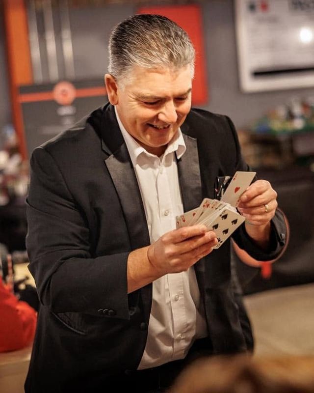 Lancashire close-up magician Darren Brand performing a card trick for guests at an event